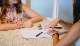 Two women discussing at a desk