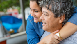 woman wrapping her arms around a man